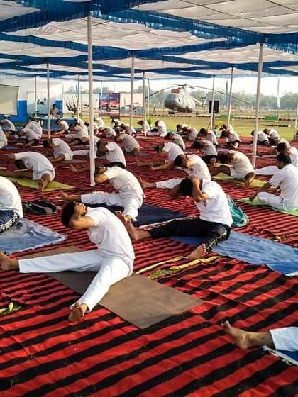 Guiding a large group of Air Force personnel through a forward bend. This asana helps to calm the mind and lengthen the spine.