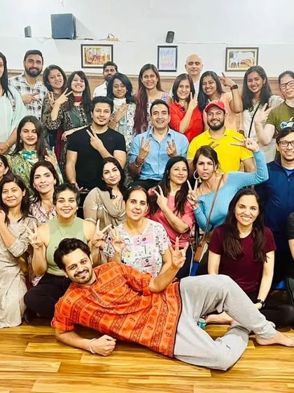 The whole Kula together. A large group photo filled with smiles, peace signs, and the wonderful chaos of our community.