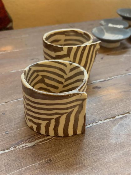 This student's quiet patience and steady curiosity shine through in these beautiful pieces from her beginner's course. The whimsical koi pond platter is a favorite, full of texture and calm joy.