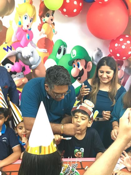 A sweet moment of dad feeding the birthday boy a piece of cake. These are the memories that last a lifetime.