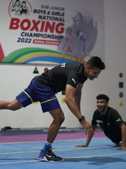 Even the coach has to show his moves sometimes. Sharing a laugh with the team during a light-hearted moment.