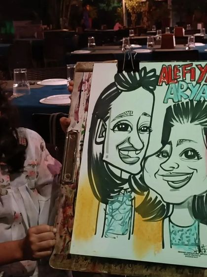 Two sisters with their joint caricature, a fun memory for them to share.