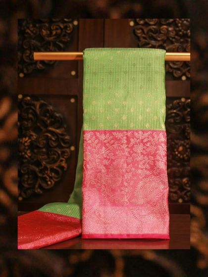 A vibrant green Kanjivaram with a contrasting pink brocade border, a joyful and festive saree.