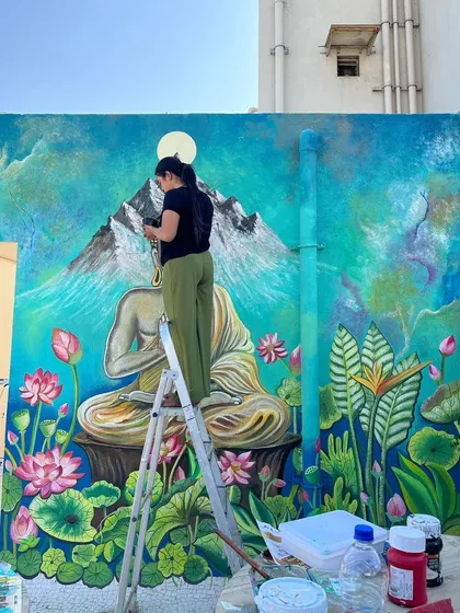 A shot of me on the ladder, completely absorbed in the process of painting this large-scale spiritual art.
