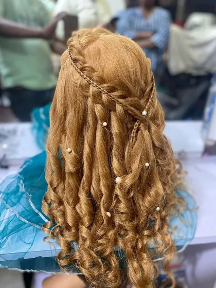Another angle of the half up style, showing the delicate pearl details scattered through the curls. My students learn to create a variety of popular and trending hairstyles.