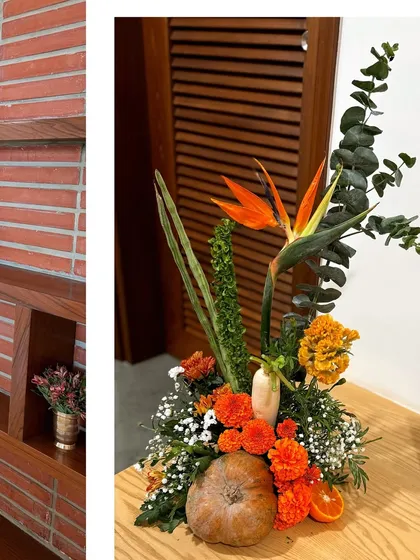 A unique floral arrangement for a housewarming, incorporating a pumpkin, bird of paradise, and other vegetables.