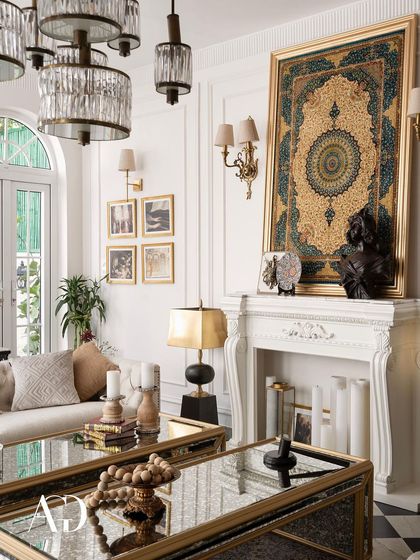 The composition of this living area is carefully balanced. The verticality of the tapestry on the mantel is echoed by the tall French doors, creating a sense of height and grandeur.