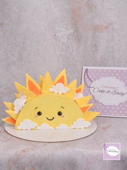 A cute and quirky half-cake shaped like a rising sun. A fun design for a bright and cheerful celebration.