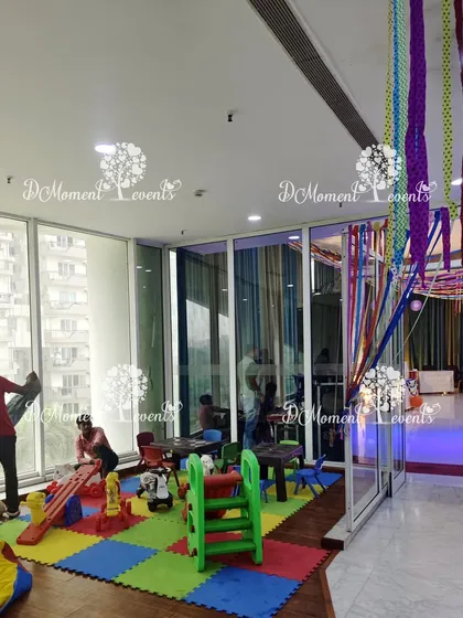 A designated play area for kids at the Art & Craft party, complete with soft mats and play equipment, ensuring the little ones are entertained.