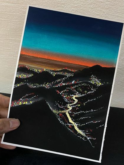 This landscape captures a city nestled in the mountains at dusk. I used oil pastels and paint to create the glowing city lights and the vibrant colors of the sunset sky.