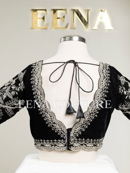 For a chic and contemporary look, I designed this black velvet blouse. It features intricate silver floral embroidery along the scalloped neckline and sleeves, creating a stunning contrast that is perfect for any special occasion.