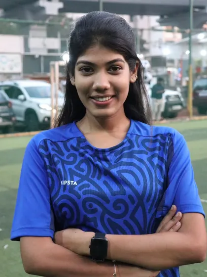Coach Shruti, a role model for our young players, especially the girls, posing with a confident smile.