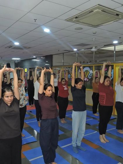 Participants stretch together, showcasing the unity and collective spirit of our school community during the yoga event.