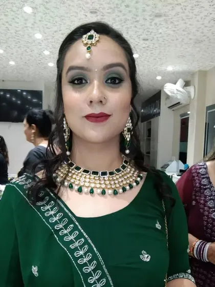 A close-up of one of our favorite party makeup looks. We focused on a dramatic smokey eye and a bold lip to match her gorgeous green lehenga.