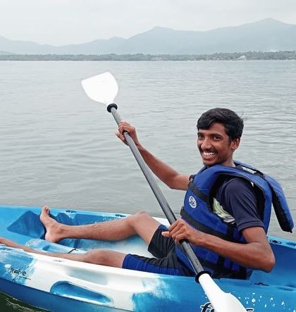 A participant enjoys a relaxing paddle in a solo kayak against the backdrop of the Karwar coastline.