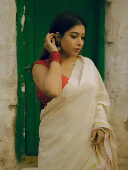 A series from an outdoor shoot, using a rustic green door as a complementary background for the red and white saree. These images show how I use color theory and natural environments to compose a shot.