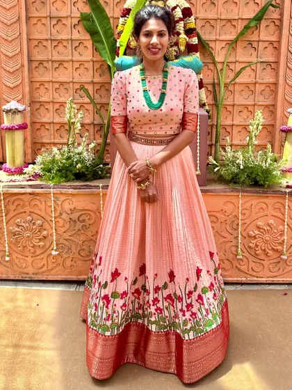 A full view of the peach anarkali, showcasing its beautiful flare and intricate border.