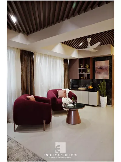 I create cozy corners for relaxation and conversation. This lounge area features plush velvet armchairs, a compact bar counter, and warm ambient lighting, making it the perfect spot for an evening drink.