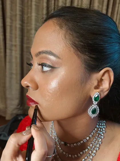 A modern Sangeet look featuring a sleek high ponytail and a bold red lip. This style is chic, comfortable, and perfect for a bride who wants to dance the night away.