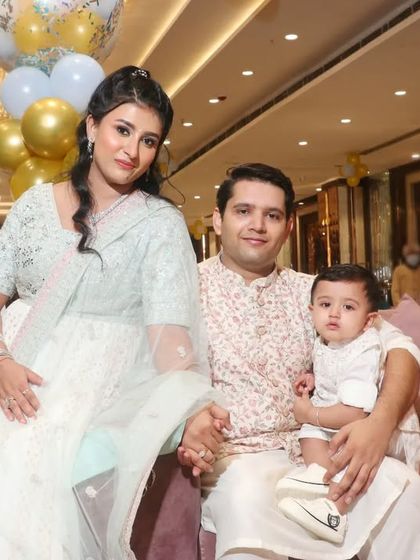 A family of three dressed in elegant traditional wear for a family function. We capture the grace and beauty of your family in their festive attire.