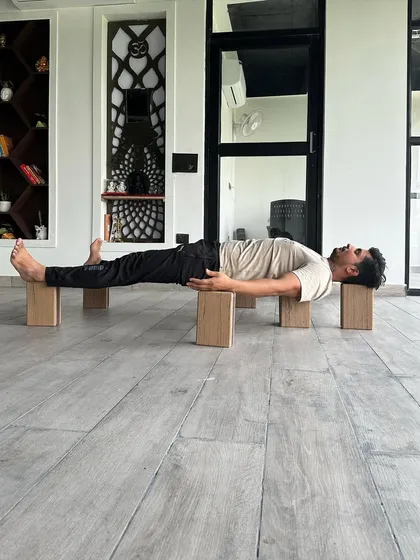 This pose, supported on blocks, is inspired by Bhishma from the Mahabharata, who lay on a bed of arrows. Supporting the body this way, especially under the heart, can induce a state of restful alertness, calming for those with cardiac issues.