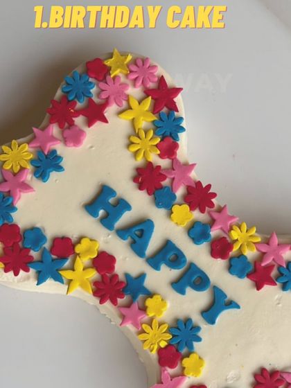 A beautiful bone-shaped cake decorated with colorful, edible flowers. This is a great option for a spring or summer birthday party.