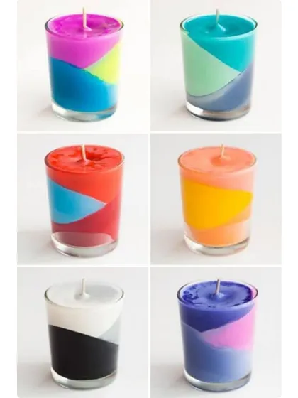 My collection of handmade multi-colored jar candles. These are perfect for adding a pop of color to any space, whether it's for party decor, hotel rooms, or as part of a gift set.