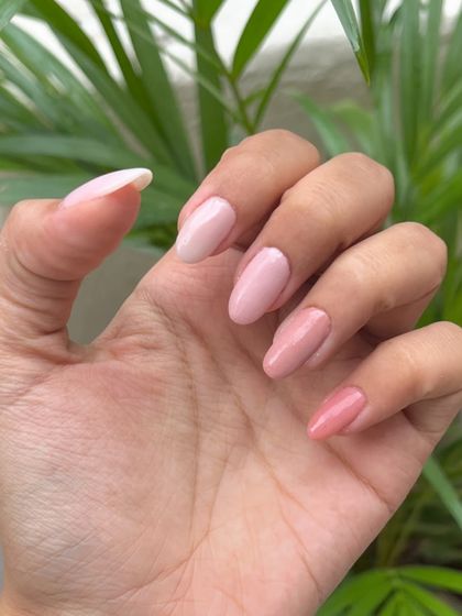 A side view of the gradient pink dip powder nails, highlighting the beautiful almond shape and the flawless application of each color.