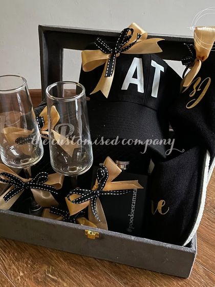 Finding the perfect gift for men can be a challenge, but this hamper has it all. It includes personalized champagne glasses, custom slippers, a monogrammed cap, and other stylish essentials.