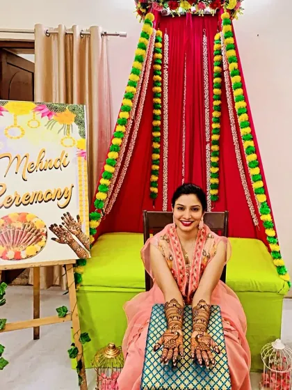 Another shot of a happy bride at her mehndi ceremony. The vibrant decor and her beautiful smile make for a perfect picture.