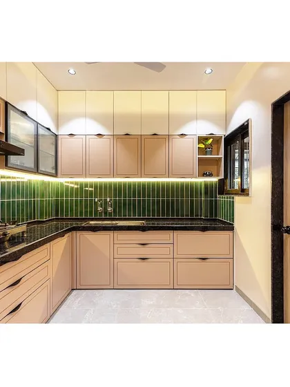 This L-shaped kitchen combines beige cabinets with a striking emerald green tiled backsplash. The design is both elegant and practical, with plenty of counter space and under-cabinet lighting.