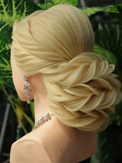 A side view of the reception bun, highlighting the twisted front variation that flows seamlessly into the textured bun. This creates a cohesive and elegant look.