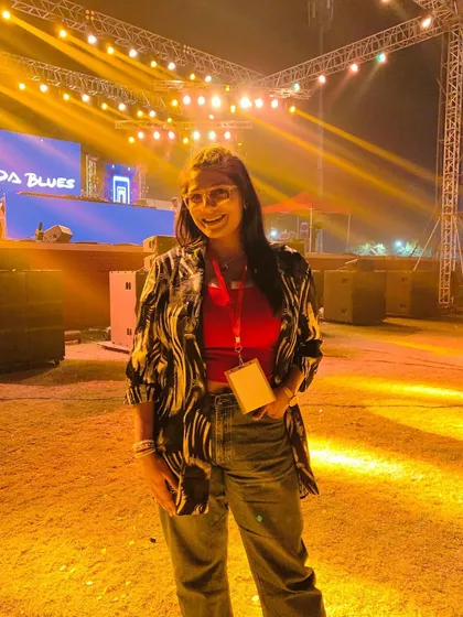 A happy moment captured during the EDM night at IIT Kanpur. The vibrant lights and roaring crowd make for an unforgettable work environment.