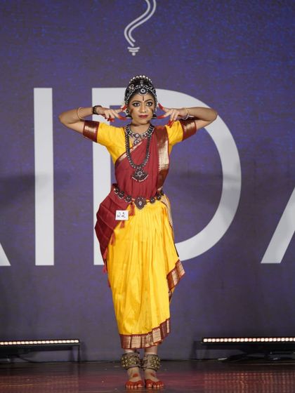 A student from our open category holding a powerful pose. Her strong performance was recognized with a 1st place award.