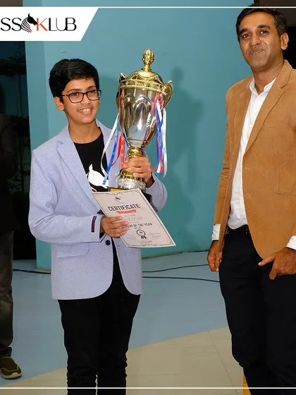 The moment of triumph! A young champion proudly holds his trophy and certificate after a stellar performance at our Chess Carnival, showcasing the rewards of dedication.