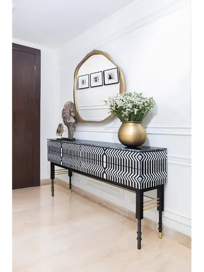 The Lella Sideboard from our Koko by K2India collection is a statement of our love for handcrafted detail. The bold, graphic inlay work paired with the sculptural Soho Mirror demonstrates how we use bespoke furniture not just as an object, but as the powerful focal point of a room's story.