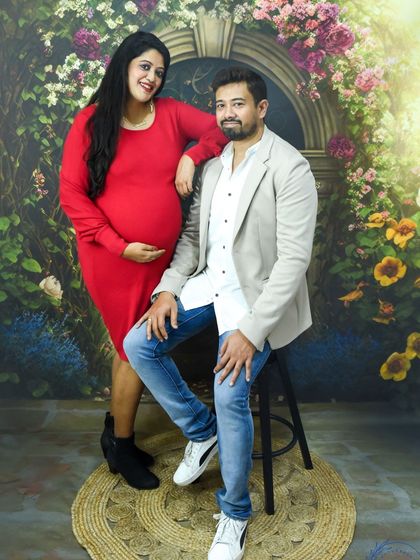 A stylish and happy couple posing together in our floral backdrop studio.