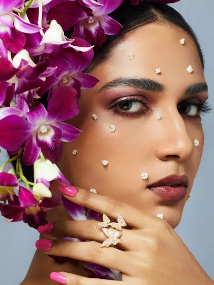A beautiful and romantic look with a soft purple smokey eye, accented with real flowers and butterfly jewelry.