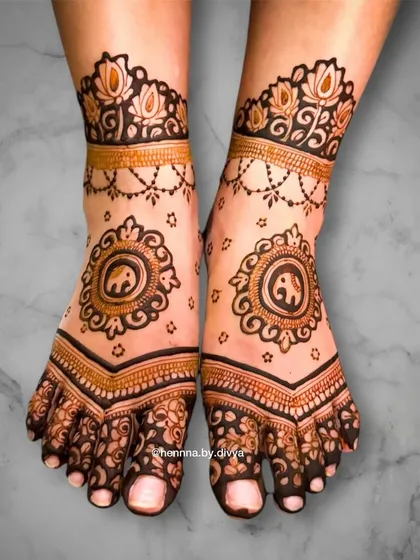 A beautiful bridal feet design featuring an elephant mandala. The pattern covers the toes and extends up the foot in a V-shape, complemented by a delicate ankle cuff.