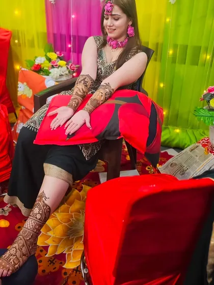 A behind-the-scenes shot of me applying leg mehndi to a bride, ensuring every detail is perfect.