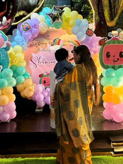 A candid moment of the birthday girl and her mom enjoying the Cocomelon backdrop I created.