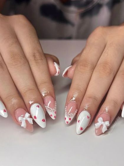 A super cute and girly set with white tips, tiny red hearts, and 3D white bows.