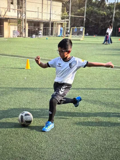 A player prepares to strike the ball during a shooting drill, showcasing the proper form and balance we teach to all our young athletes.