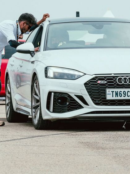 An Audi RS5, a perfect blend of luxury and performance, gets final checks before hitting the track.