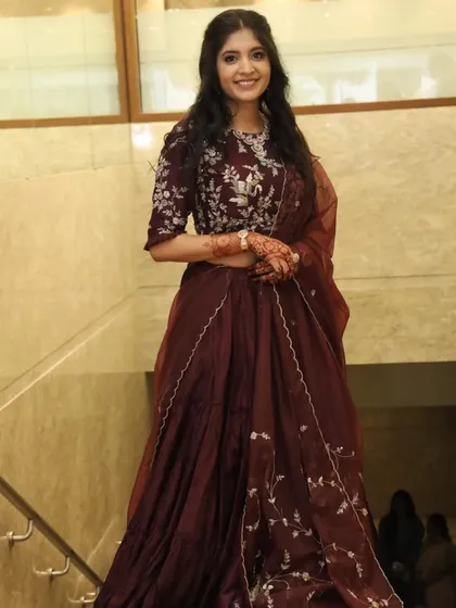 The complete look for this gorgeous engagement bride. The deep wine color of her lehenga was complemented by a soft, romantic makeup style.