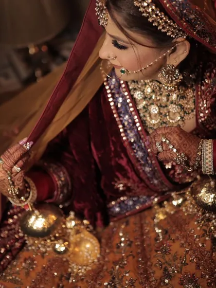 A beautiful shot of the bride looking down at her kaleeras, a classic moment from a Punjabi wedding.