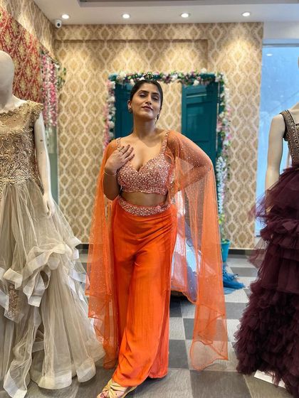 A full view of the orange two-piece Indo-Western outfit. It is a modern, stylish, and comfortable option for anyone who wants to try something different for a wedding function.