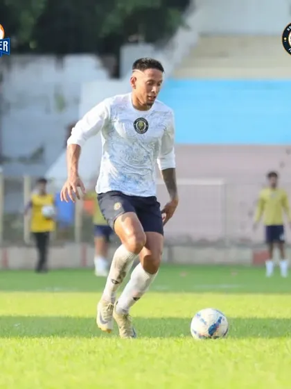 A player dribbles with focus, looking for the right moment to make a decisive move.