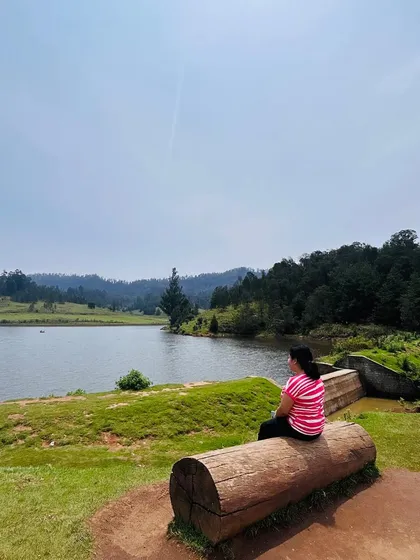 A traveler enjoying a moment of peace by the lake in Kodaikanal.