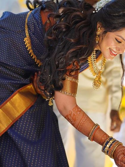 A candid moment of joy from her engagement ceremony. The dewy makeup finish catches the light beautifully, highlighting her smile.